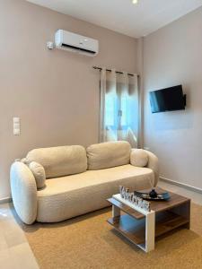 a living room with a couch and a table at STV Royal Apartments 3 in Areopoli