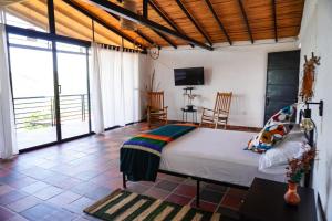 a bedroom with a bed and a television in it at Casa Luna Hotel Campestre & Spa in San Gil