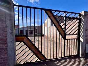 a wooden gate with a wooden railing on a deck at René Favaloro in Rincon de los Sauces
