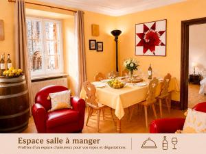 a dining room with a table and red chairs at La Terrasse du Tonnelier - 92m2 - plein centre médiéval - sauna - terrasse 20m2 - garage in Kaysersberg +25 photos