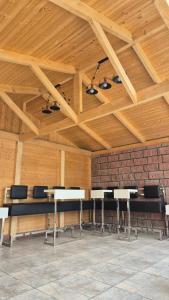 a room with wooden ceilings and tables and chairs at Busheti Home in Telavi +74 photos