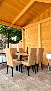 a wooden table and chairs on a patio at Busheti Home in Telavi