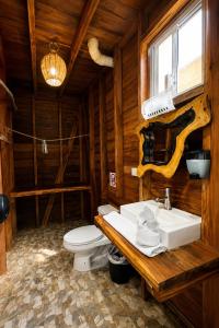 a bathroom with a white sink and a toilet at Hotelito Villas Holbox - Self Check In in Holbox Island
