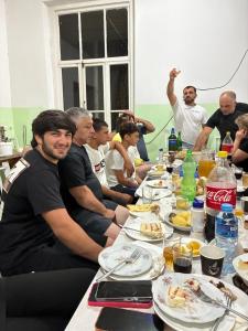 a group of people sitting around a long table with food at Tolia in Ureki