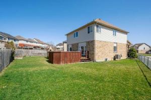 a house with a yard with a fence at Quiet Room 2 in kitchener in Kitchener