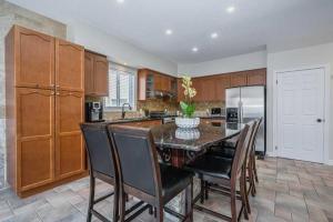 a kitchen with a table and chairs and a refrigerator at Quiet Room 2 in kitchener in Kitchener