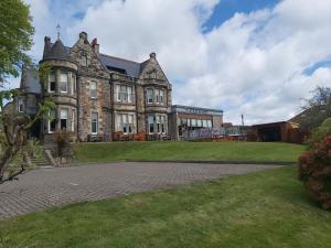 a large building with a grassy yard in front of it at The Strathearn Hotel in Fife