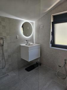 a bathroom with a sink and a mirror at FOREST apartments in Bijela