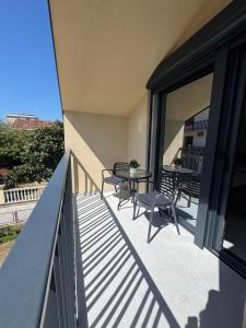 a balcony with a table and chairs on it at FOREST apartments in Bijela