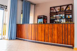 a bar with a wooden counter in a room at Gugga Suites Mbale in Mbale +19 photos