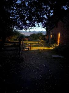 a house with a fence in front of a yard at Debdale Bus Retreat in Little Dalby