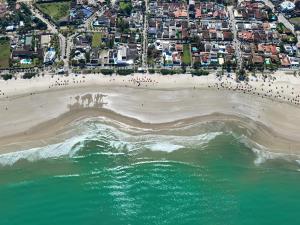 an aerial view of a beach with a crowd of people at HOSTEL QUINTAL GUEST - Guarujá in Guarujá +73 photos