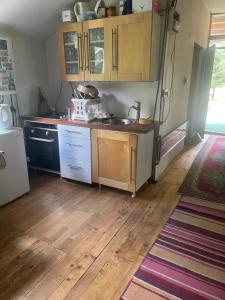a kitchen with a sink and a refrigerator at Sopotnica - Apartman na vodopadima in Prijepolje +10 photos