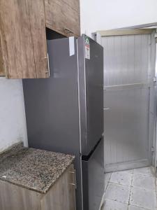 a kitchen with a stainless steel refrigerator and cabinets at Al-Ahmari Holiday Apartment in Mogadishu