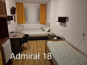 a small room with two beds and a desk at Bursztyn in Władysławowo