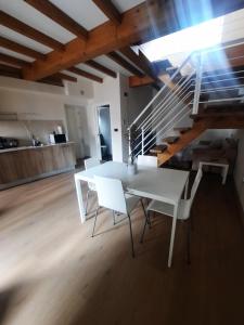 a white dining room with a white table and chairs at Vista Real in Mugardos