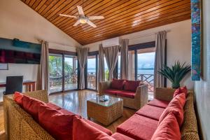 a living room with a couch and a ceiling fan at Hotel Palma Royale in Bocas Town