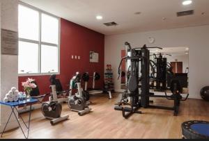 a gym with several tread machines in a room at Flat em Alphaville Hotel Comfort in Barueri