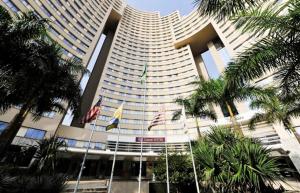 a large building with flags in front of it at Flat em Alphaville Hotel Comfort in Barueri