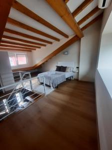 a attic bedroom with a bed and a table at Vista Real in Mugardos