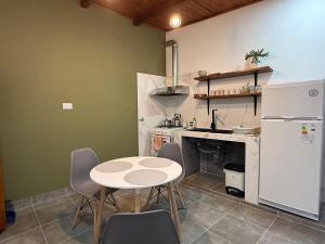 a kitchen with a table and a white refrigerator at Usina Elias in Tilcara