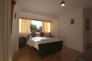 a bedroom with a large bed and a window at Piedra Wasi Ecolodge Urubamba in Urubamba