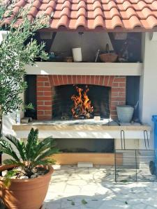 a brick fireplace with a fire inside of it at Apartments Marino in Supetar