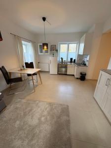 a living room with a table and a kitchen at Landglück in Ibbenbüren