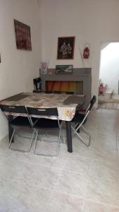 a ping pong table with two chairs in a room at Casa relax Mele in Siniscola