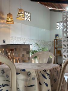 a table with chairs and a table cloth on it at Maruva Chalé in Aquiraz +17 photos