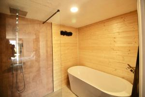 a bathroom with a bath tub and a shower at Lodge Les Cariolettes in Font-Romeu-Odeillo-Via +30 photos