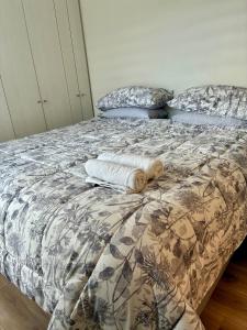 a bed with a cat laying on top of it at Marina del Sol Executive Apartment in Talcahuano