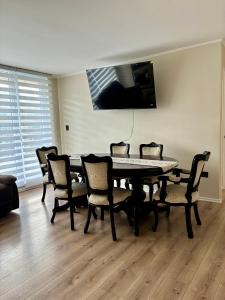 a dining room with a table and chairs at Marina del Sol Executive Apartment in Talcahuano