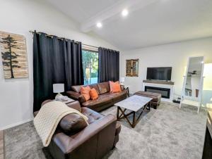 a living room with a couch and a table at Mountview Maison in Red Deer