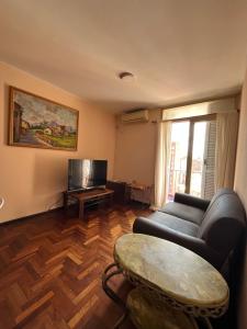 a living room with a couch and a table at Departamento zona sur 1 dormitorio in Santa Fe