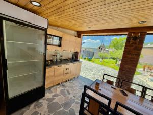 a large kitchen with a large refrigerator and a table at Home Ler in Yeghipatrush