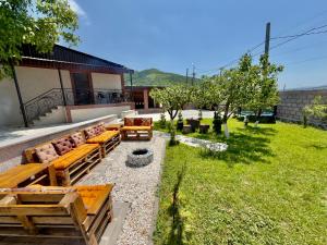 a patio with couches and a fire pit in a yard at Home Ler in Yeghipatrush