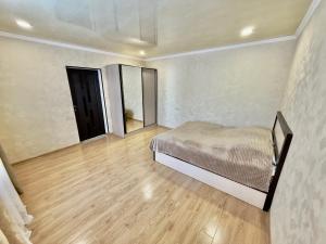a bedroom with a bed and a wooden floor at Home Ler in Yeghipatrush +12 photos