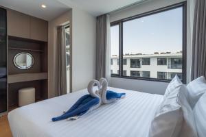 a bedroom with two stuffed animals on a bed at New Capri Condo in Bang Tao by Lofty in Ban Thalat Choeng Thale +36 photos