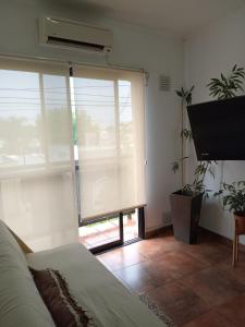 a bedroom with a bed and a large window at Alojamiento Las Camelias in Concordia