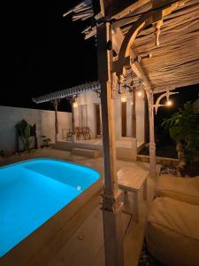 a swimming pool in a backyard at night at Romantic private villas Buvillas nusa penida in Nusa Penida +18 photos