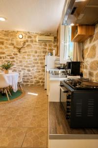 a kitchen with a stove and a table in a room at Casa Rapata in Gaios