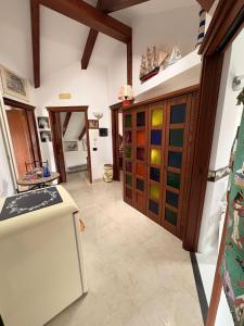 a kitchen with colorful glass cabinets and a refrigerator at Toni's in Pianillo