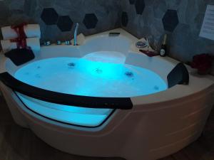 a jacuzzi tub with blue lights in a bathroom at Il Mare Di Roma Luxury in Lido di Ostia