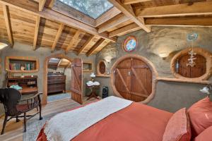 a bedroom in a tree house with a bed and a desk at Hobbit Hideout in Watsonville