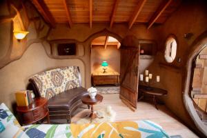 a room in a house with a couch and a table at Hobbit Hideout in Watsonville