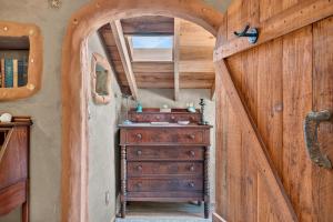 a wooden hallway with a dresser in a room at Hobbit Hideout in Watsonville +159 photos