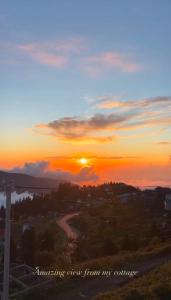 a sunset with the words awakening them from my universe at Gomismta Golden Hour Cottages in Gomi
