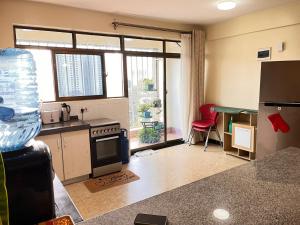 a kitchen with a stove and a counter top at Floma Homes in Nairobi