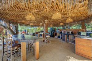 a kitchen with a table and some chairs and a counter at Hobbit Hideout in Watsonville